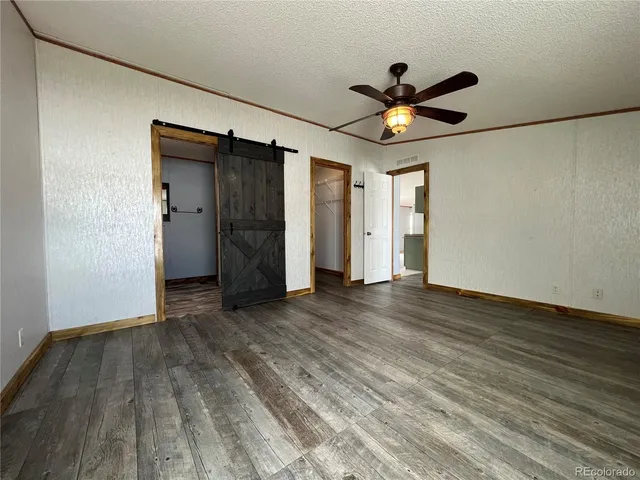 a view of an empty room with a ceiling fan