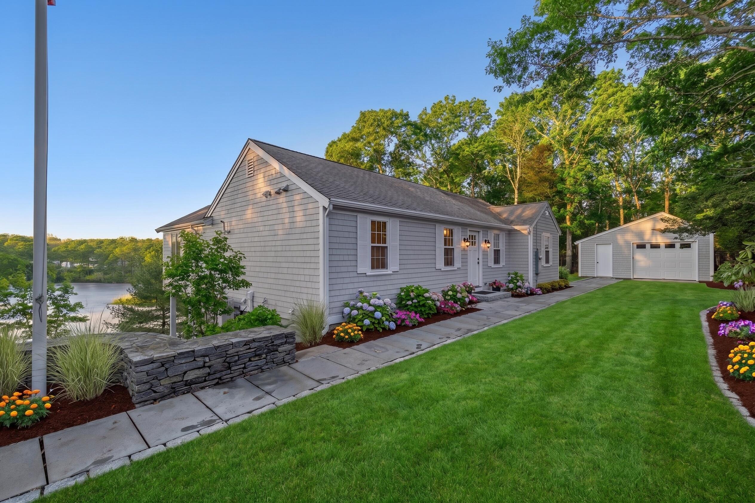 162 Main Street Osterville, MA 02655 - Photo 1 of 50 a front view of a house with garden