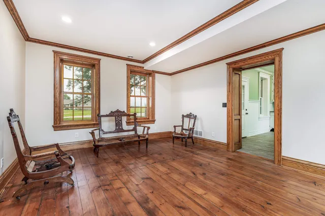 a living room with furniture and two window