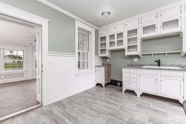 a kitchen with stainless steel appliances cabinets and a window