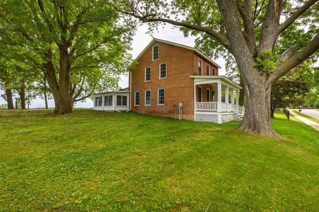 a front view of house with yard and green space