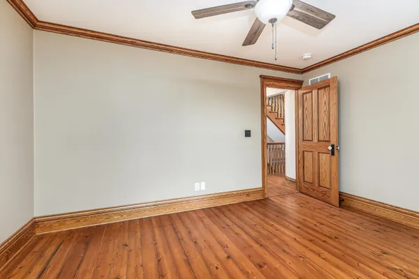 a red house with trees in front of it
