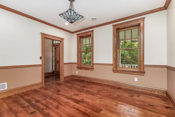 a view of a livingroom with wooden floor and a window