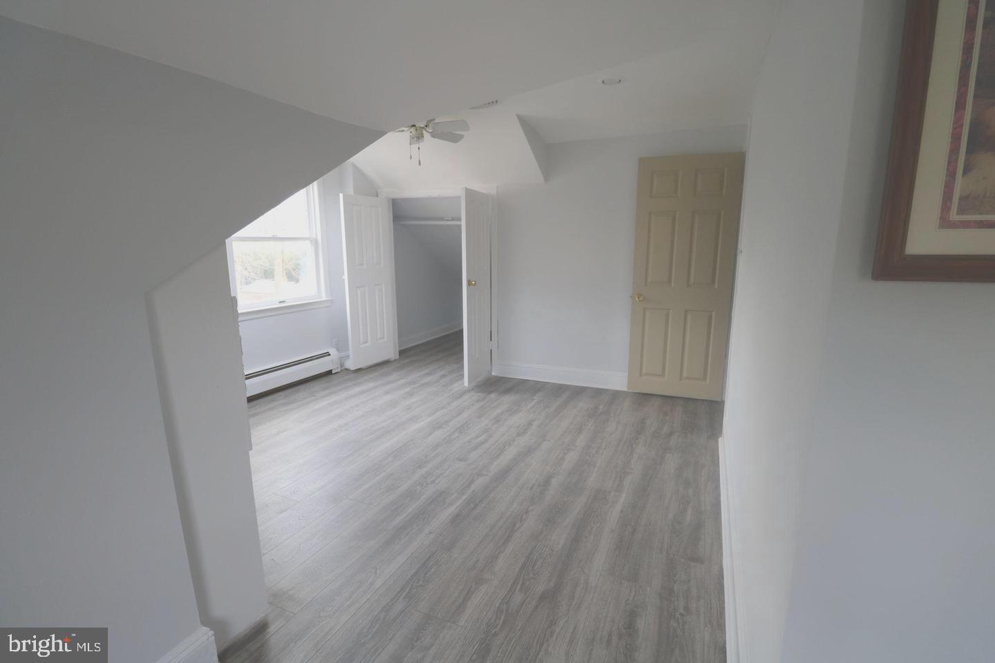 1637 Pennington Road Ewing, NJ 08618 - Photo 20 of 56 an empty room with wooden floor and windows