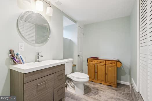 1637 Pennington Road Ewing, NJ 08618 - Photo 22 of 56 a bathroom with a toilet sink vanity and mirror