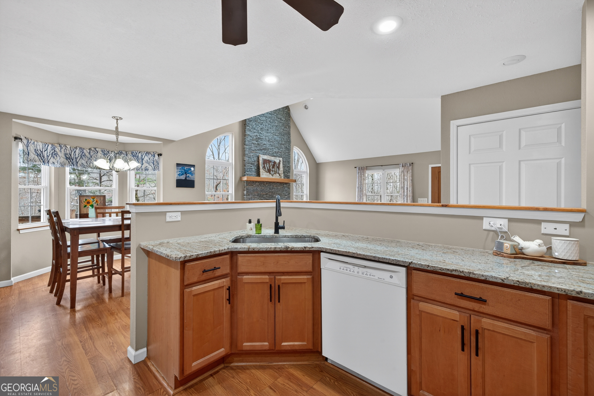 756 Gordon Thomas Road Blairsville, GA 30512 - Photo 11 of 65 a kitchen with granite countertop a sink a stove cabinets and wooden floor