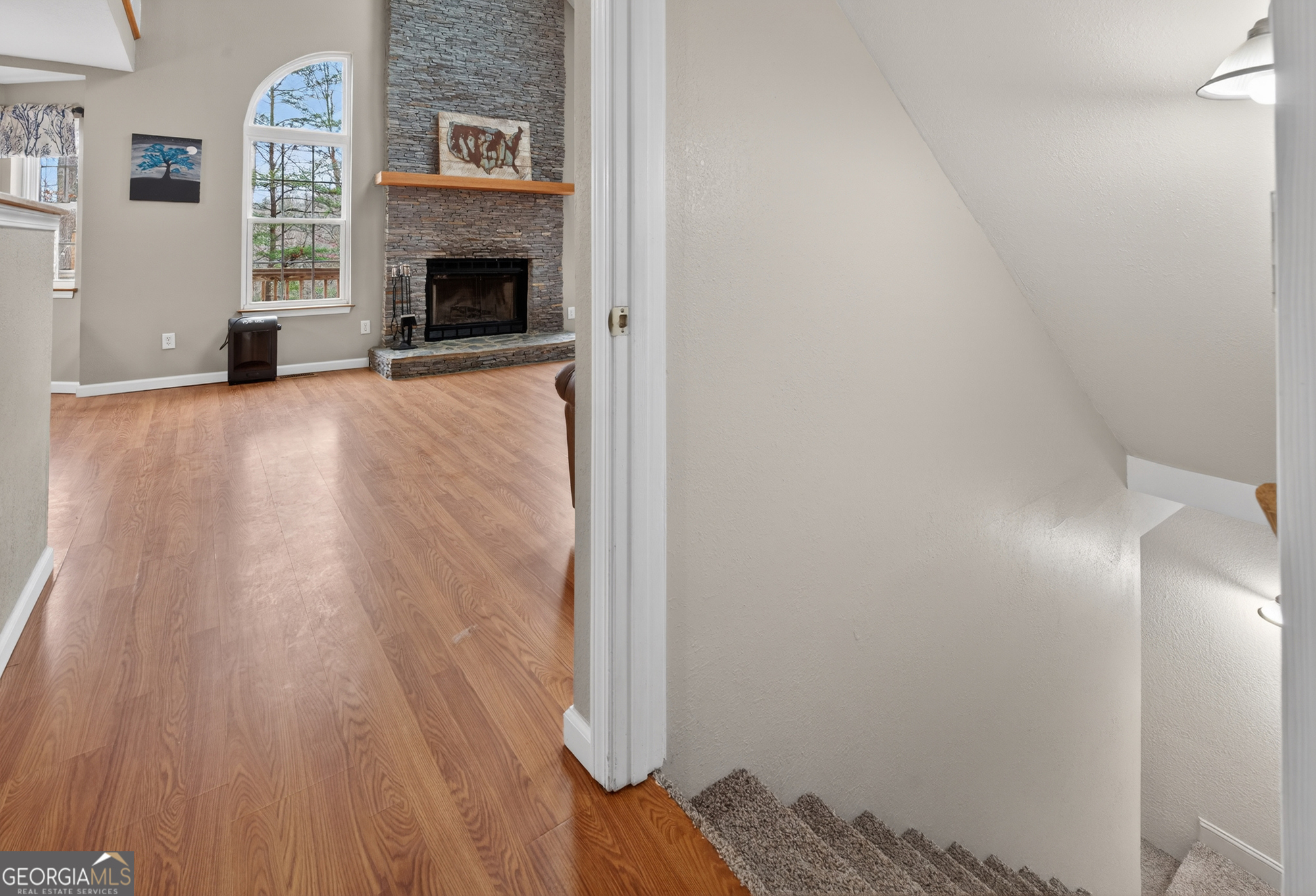 756 Gordon Thomas Road Blairsville, GA 30512 - Photo 34 of 65 a view of a livingroom with wooden floor and a fireplace