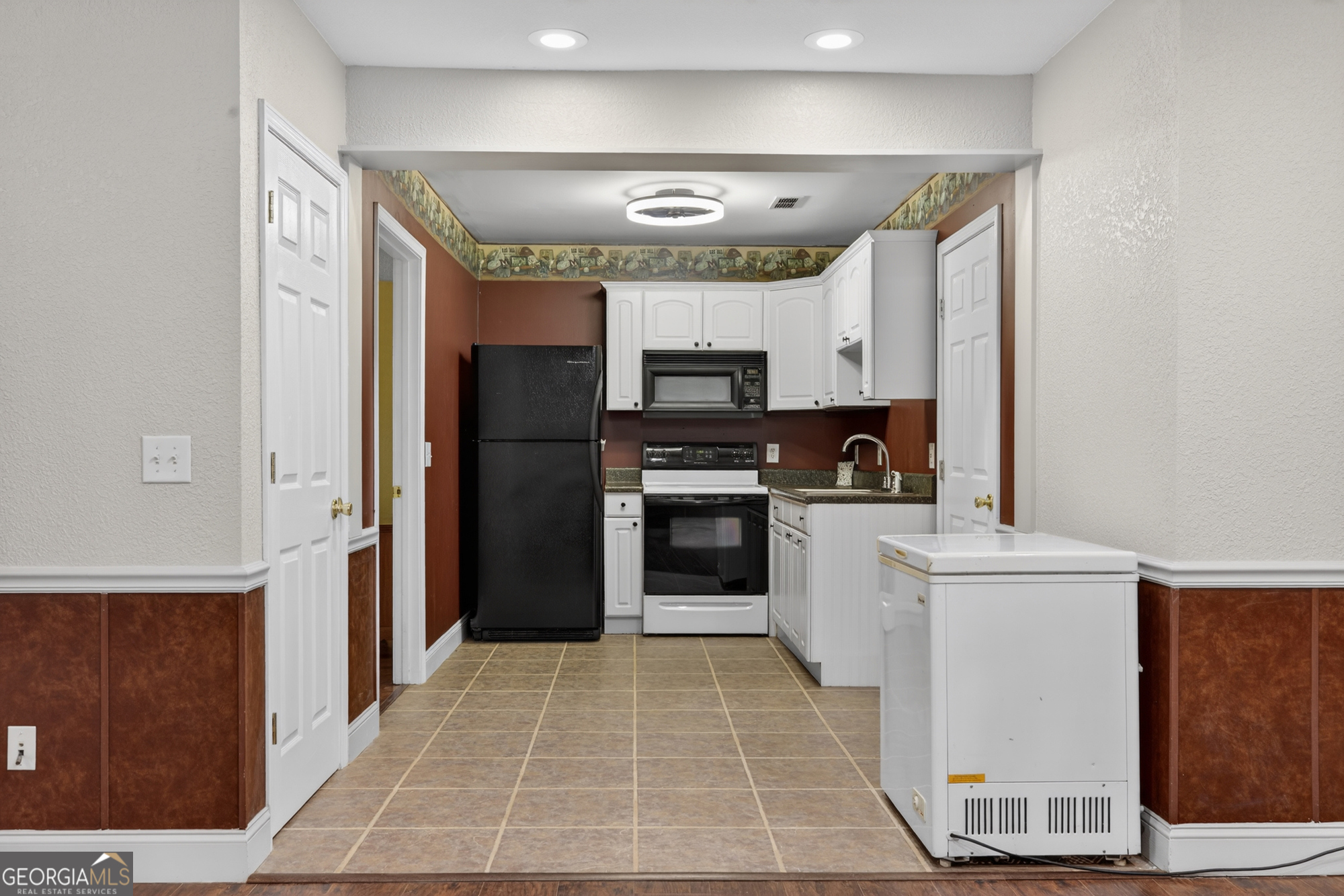 756 Gordon Thomas Road Blairsville, GA 30512 - Photo 38 of 65 a kitchen with stainless steel appliances granite countertop a refrigerator and a stove