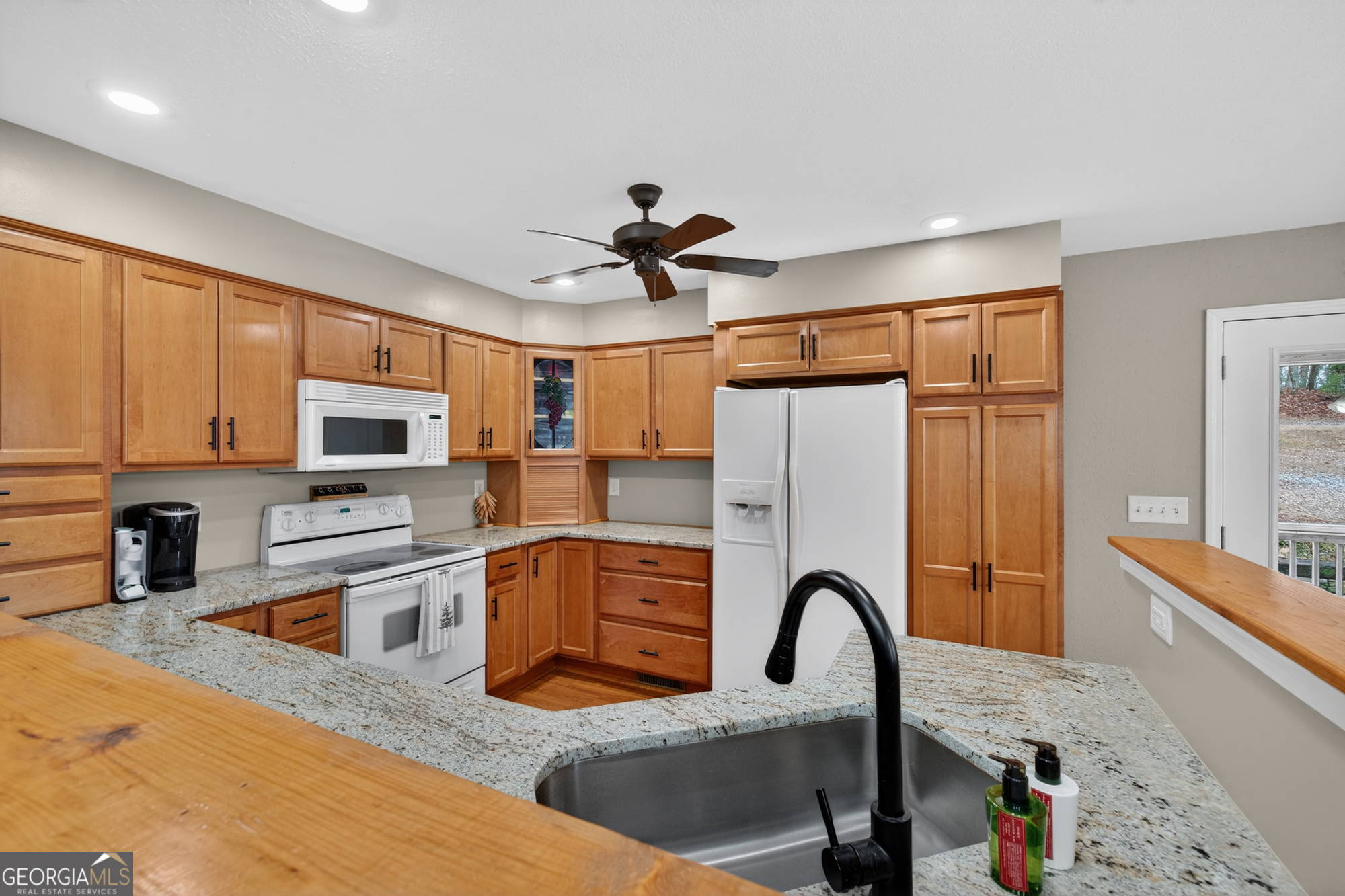 756 Gordon Thomas Road Blairsville, GA 30512 - Photo 10 of 65 a kitchen with stainless steel appliances granite countertop a refrigerator a stove a sink dishwasher and white cabinets with wooden floor