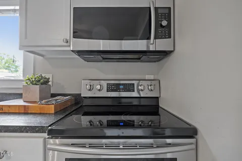 a kitchen with a table chairs refrigerator and cabinets