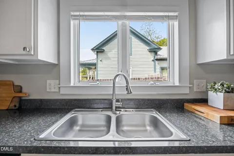 a living room with a stove and a microwave