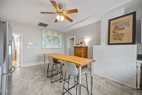 a dining room with a table and chairs