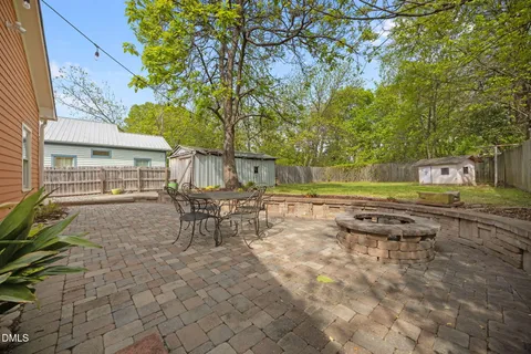 a view of a house with a yard and furniture