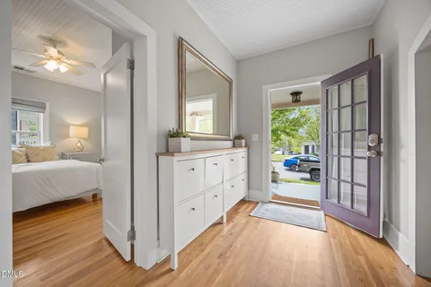 a kitchen with stainless steel appliances a refrigerator a stove a sink dishwasher a stove and white cabinets with wooden floor