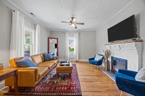 a living room with furniture and a chandelier