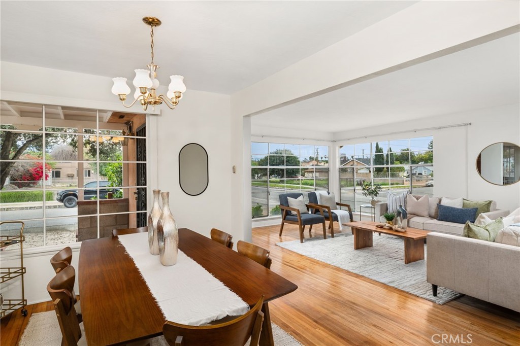 1203 Ohio Street Redlands, CA 92374 - Photo 6 of 27 a dining room with wooden floor a chandelier a glass table and chairs