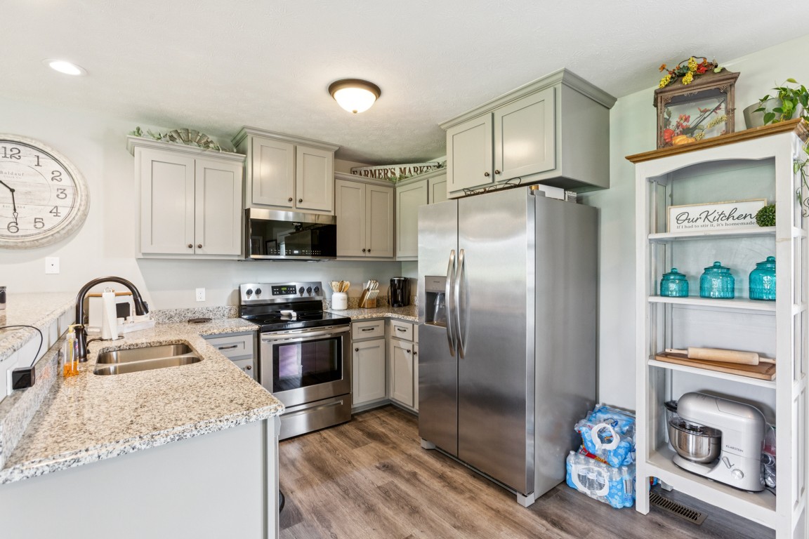 4510 Long Creek Road Lafayette, TN 37083 - Photo 11 of 25 a kitchen with stainless steel appliances granite countertop a refrigerator and a stove top oven