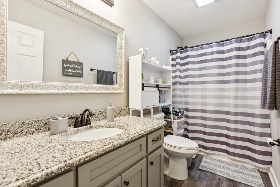 4510 Long Creek Road Lafayette, TN 37083 - Photo 19 of 25 a bathroom with a granite countertop sink mirror vanity and toilet