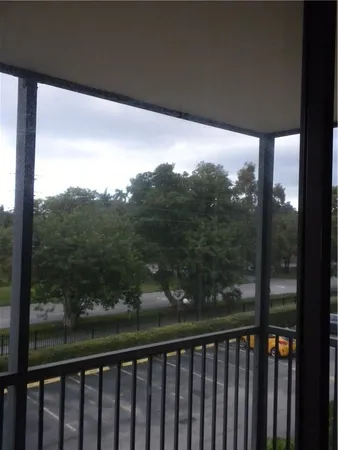 a view of a balcony with yard