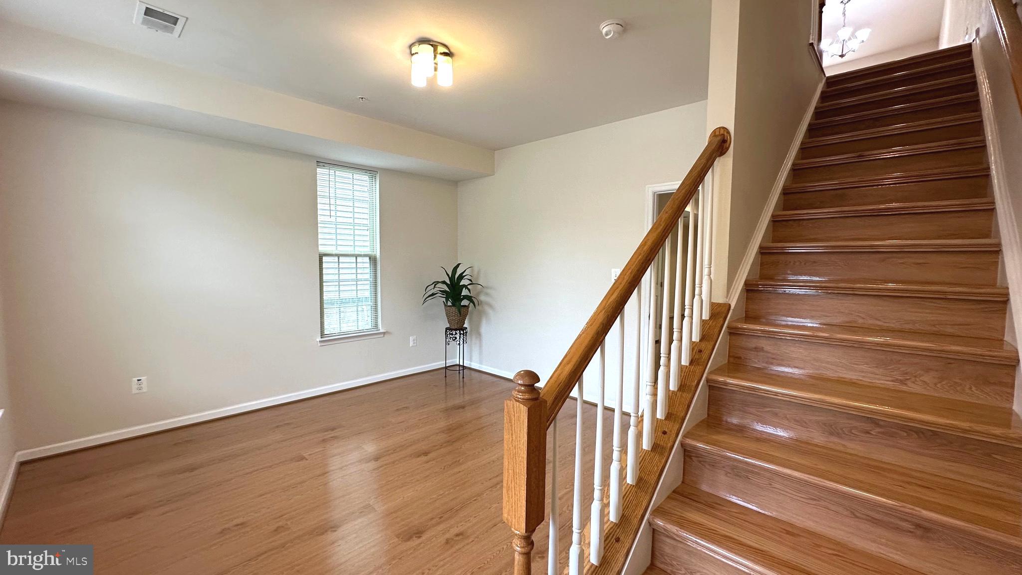 7343 Old Calvary Road Hanover, MD 21076 - Photo 4 of 35 wooden floor in an empty room with a window