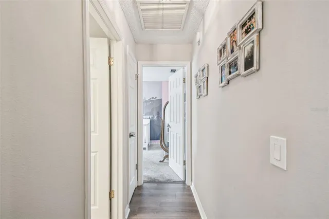 a bedroom with a bed couch chandelier and a window