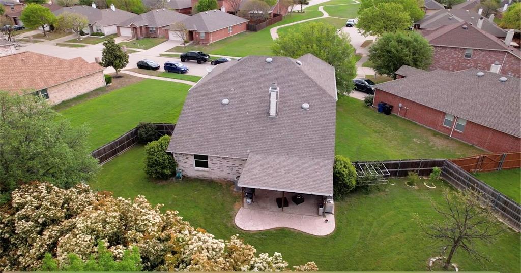 an aerial view of a house with a garden and parking space
