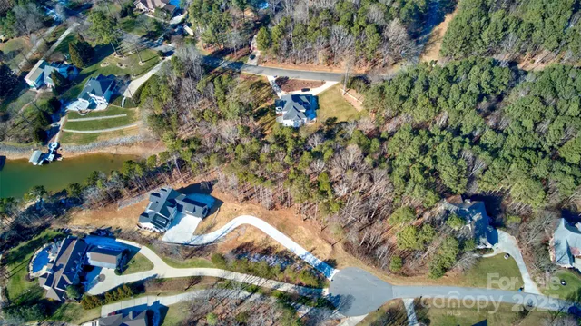 an aerial view of a houses with a lake view and mountain view