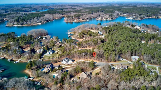an aerial view of lake residential house with outdoor space and trees around