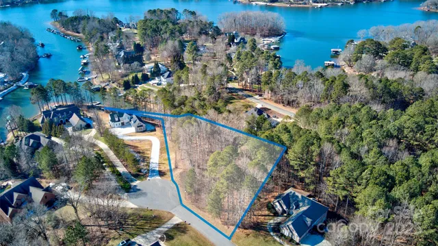 an aerial view of residential house with outdoor space and trees
