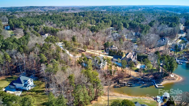 an aerial view of a houses with outdoor space and lake view