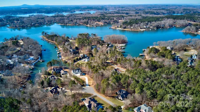 an aerial view of a houses with outdoor space and lake view