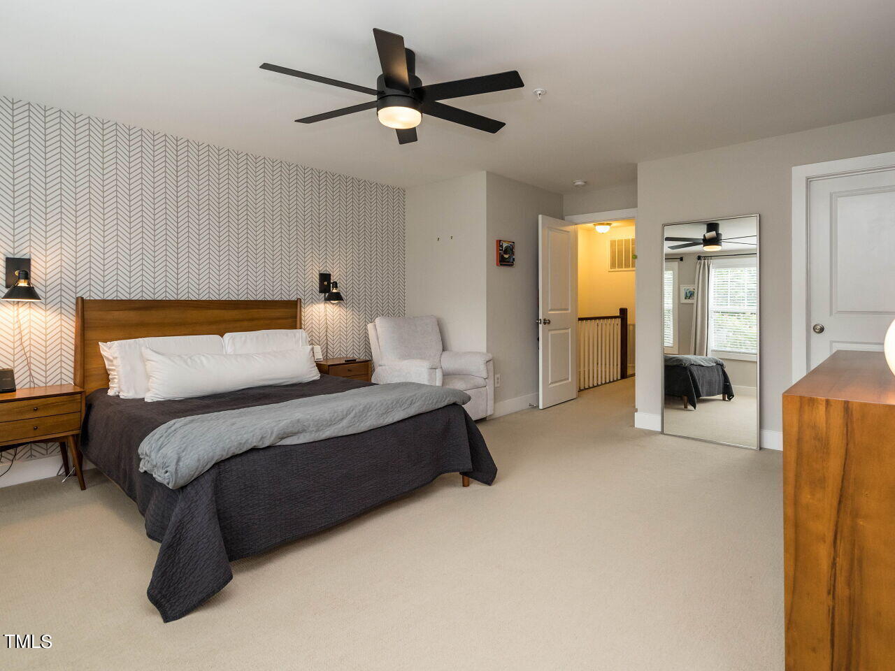 531 North Person Street, Unit 105 Raleigh, NC 27604 - Photo 16 of 25 a bedroom with a large bed and ceiling fan