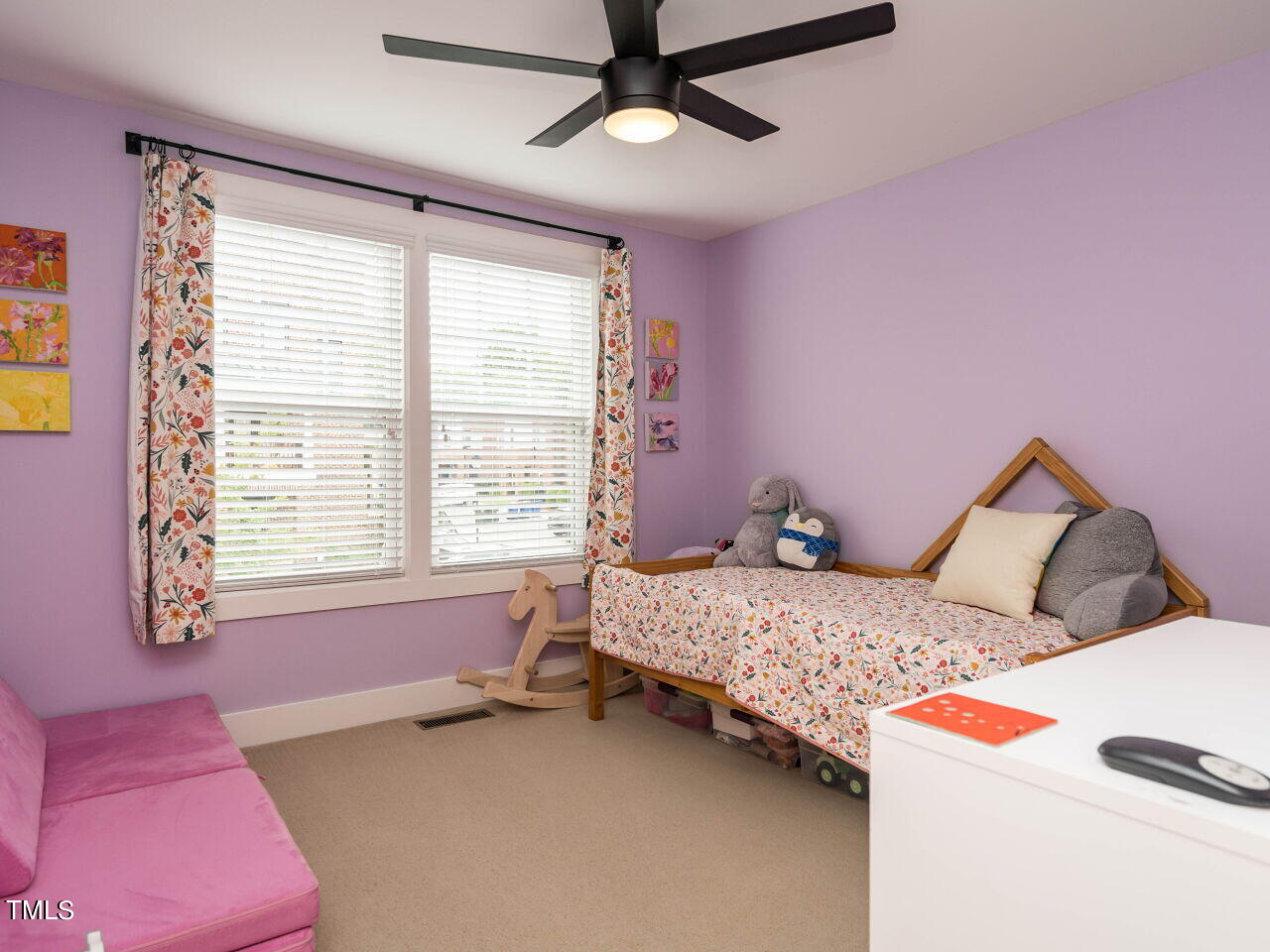 531 North Person Street, Unit 105 Raleigh, NC 27604 - Photo 19 of 25 a bedroom with a bed and a dresser next to a window
