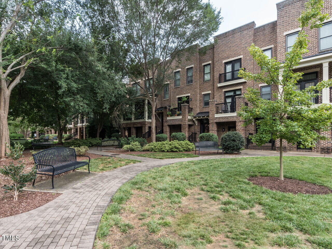 531 North Person Street, Unit 105 Raleigh, NC 27604 - Photo 24 of 25 a view of a house with a yard and sitting area