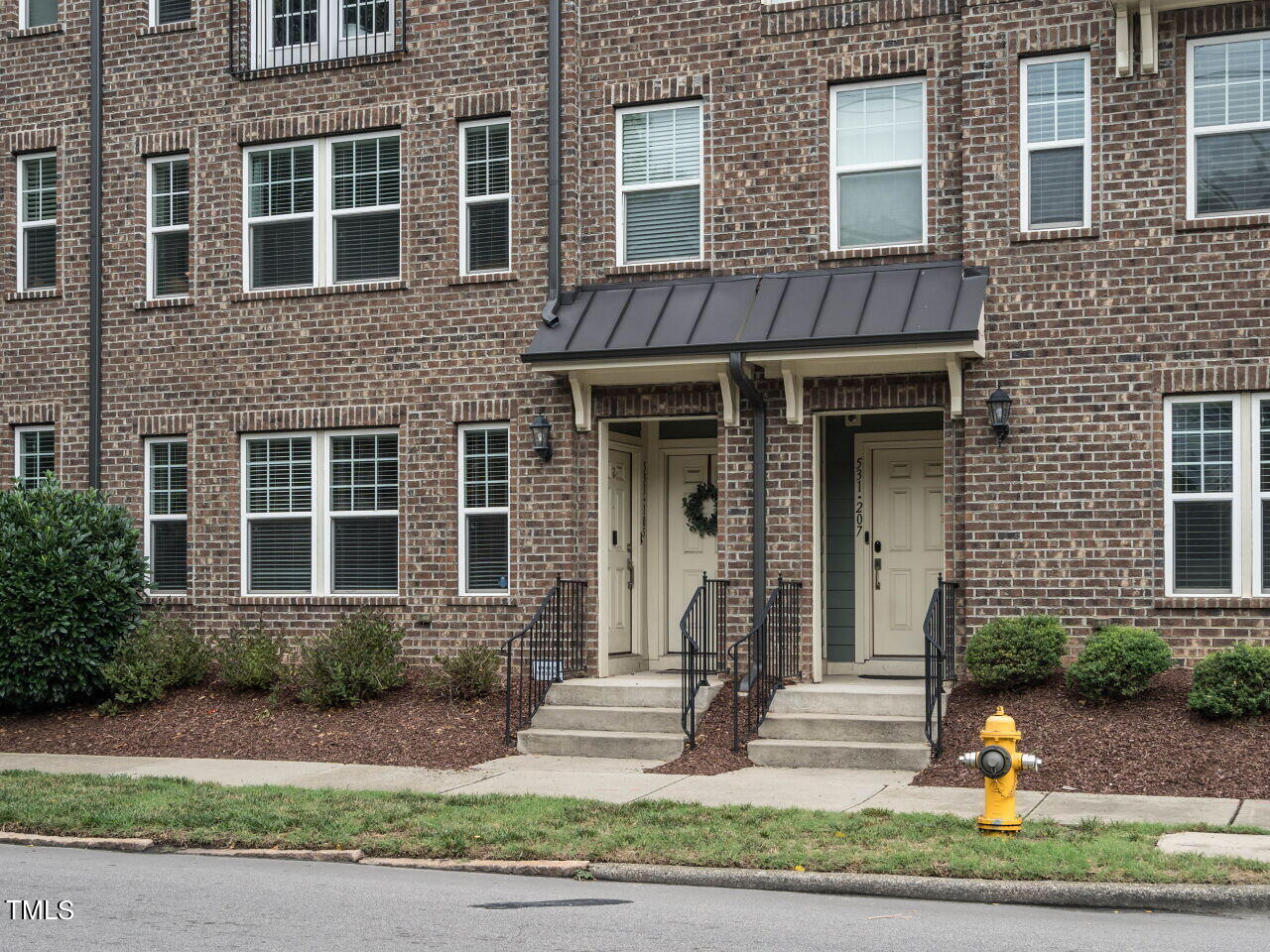 531 North Person Street, Unit 105 Raleigh, NC 27604 - Photo 3 of 25 a front view of a house with garden