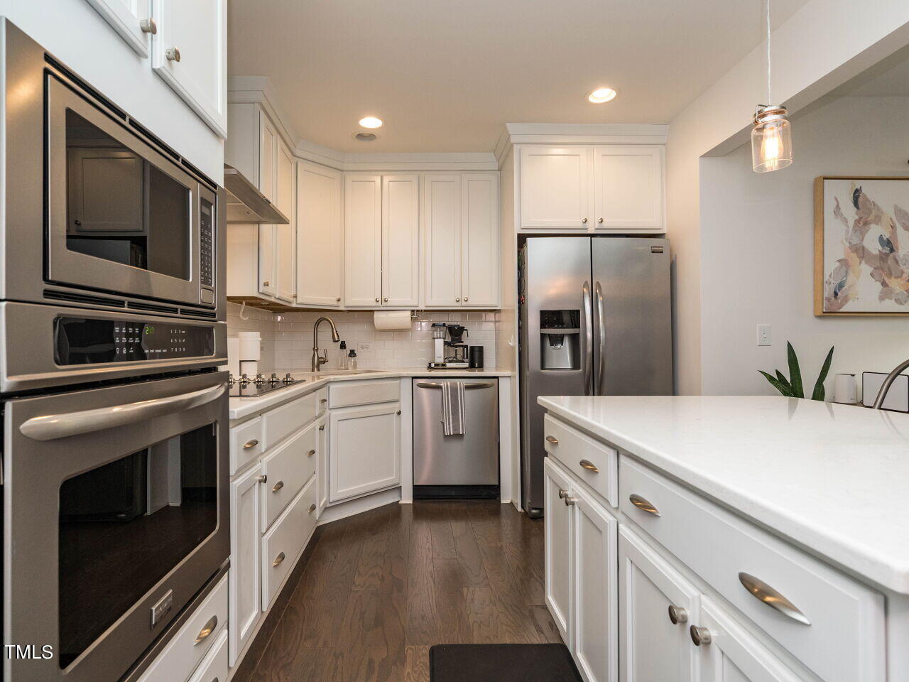 531 North Person Street, Unit 105 Raleigh, NC 27604 - Photo 9 of 25 a kitchen with stainless steel appliances a refrigerator sink and microwave