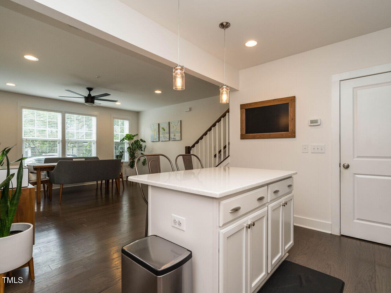 531 North Person Street, Unit 105 Raleigh, NC 27604 - Photo 10 of 25 a view of kitchen center island dining table wooden floor and windows