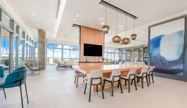 a room with pool table and windows