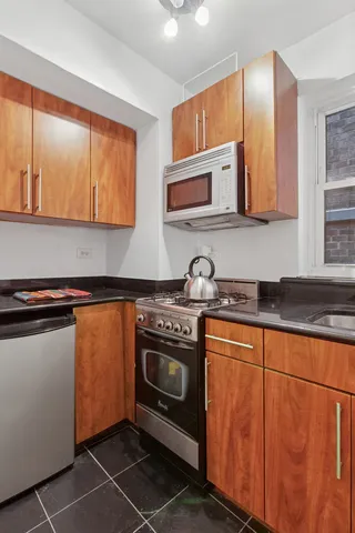 a bathroom with a sink toilet tub and shower