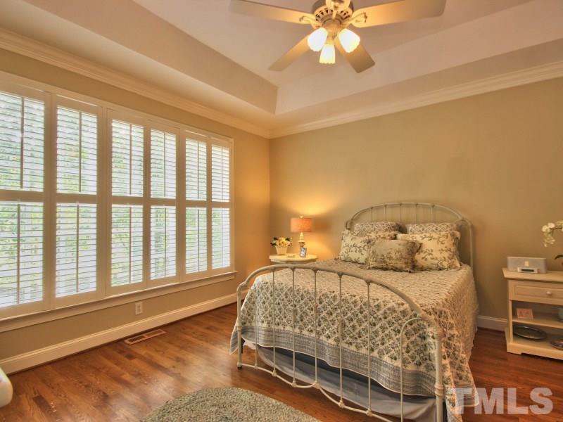 164 Yorkchester Way, Unit 13 Raleigh, NC 27615 - Photo 12 of 23 a bed sitting in a bedroom next to a window