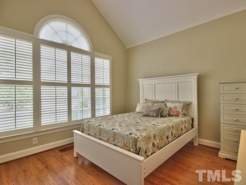 164 Yorkchester Way, Unit 13 Raleigh, NC 27615 - Photo 15 of 23 a bedroom with a bed and a large window