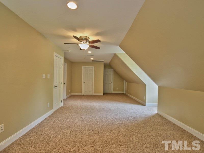 164 Yorkchester Way, Unit 13 Raleigh, NC 27615 - Photo 19 of 23 an empty room with a ceiling fan and a window