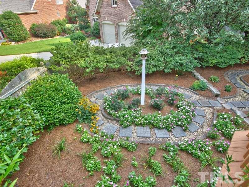 164 Yorkchester Way, Unit 13 Raleigh, NC 27615 - Photo 22 of 23 a view of a garden with a building