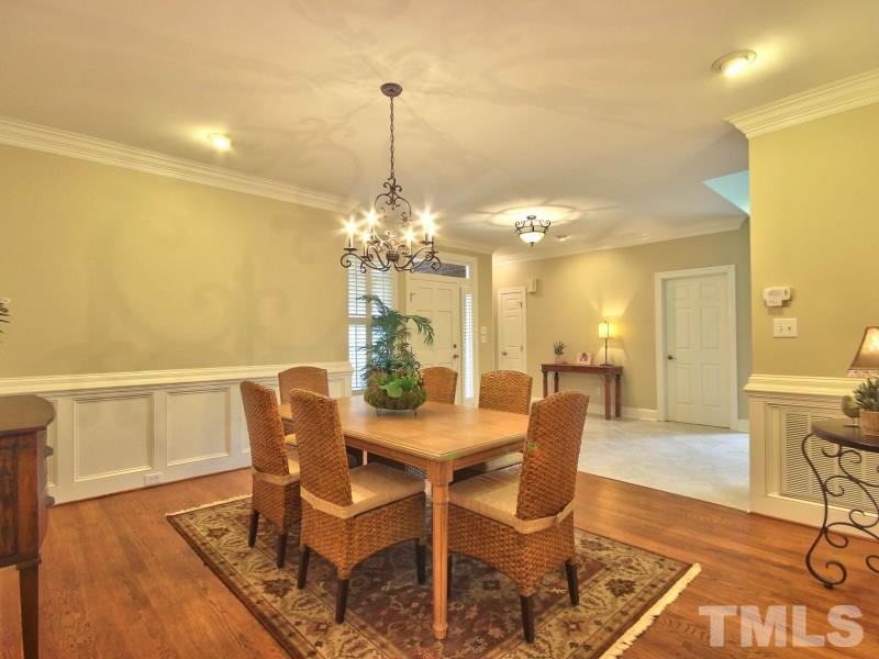 164 Yorkchester Way, Unit 13 Raleigh, NC 27615 - Photo 8 of 23 a view of a dining room with furniture a chandelier and wooden floor