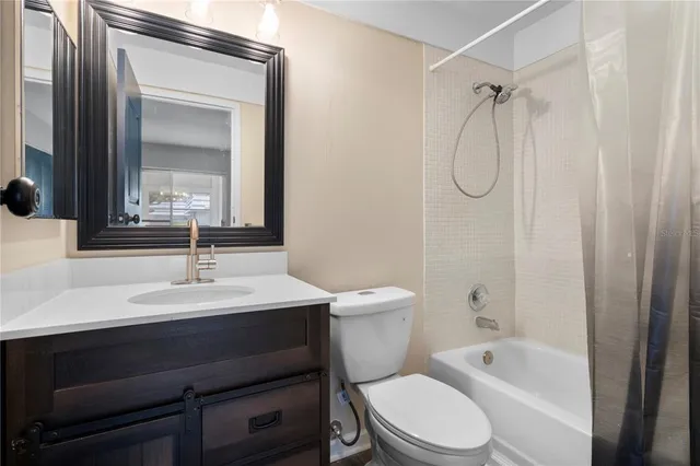 a bathroom with a sink toilet vanity and shower