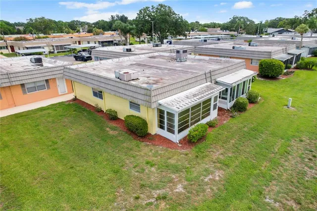 an aerial view of a house having yard and patio