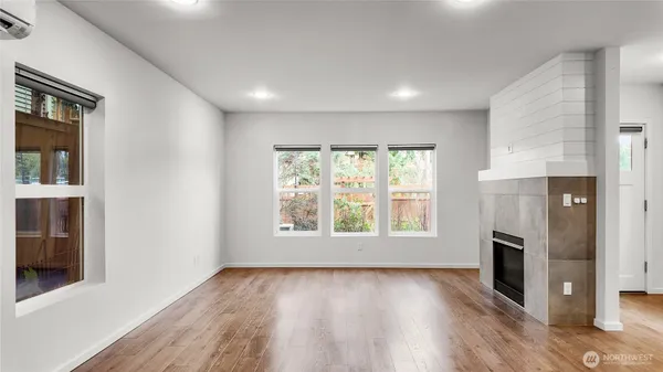 an empty room with wooden floor and a window