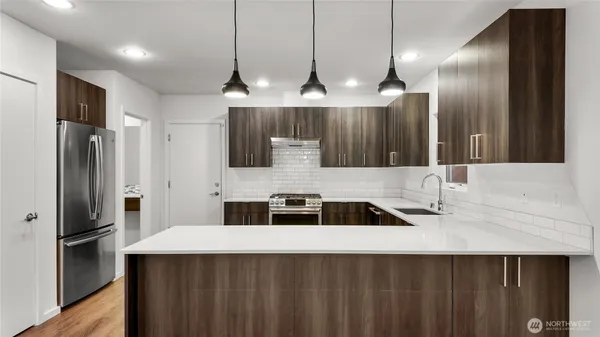 a kitchen with stainless steel appliances a sink and a refrigerator
