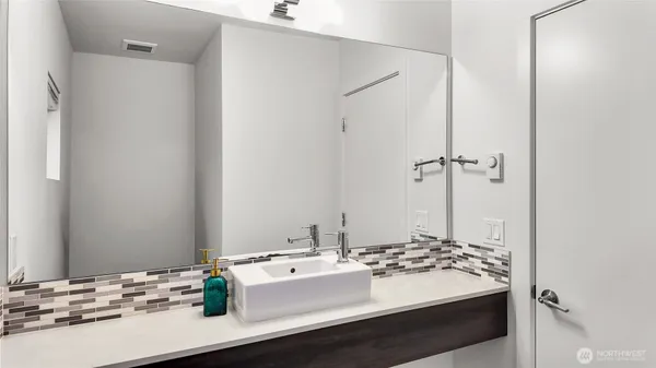 a bathroom with a sink and a mirror