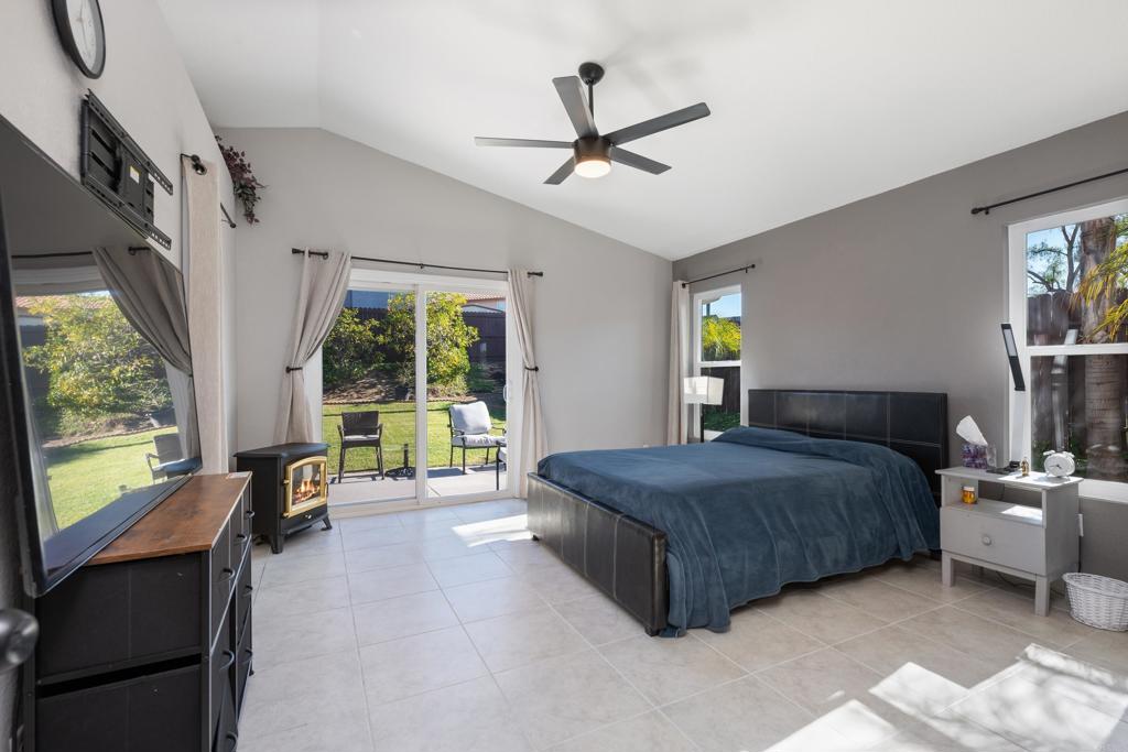 5331 Mead Street Oceanside, CA 92056 - Photo 11 of 29 a spacious bedroom with a bed a table and large windows